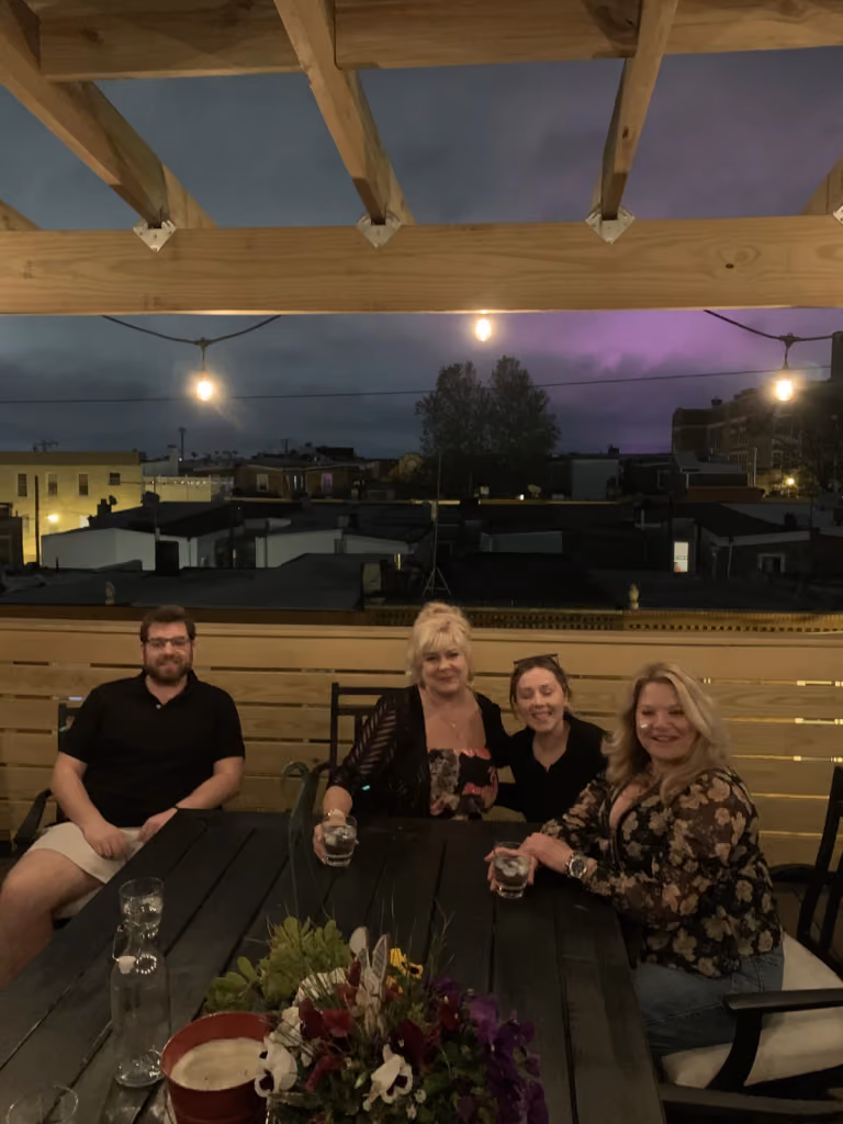 An evening gathering beneath the finished pergola.