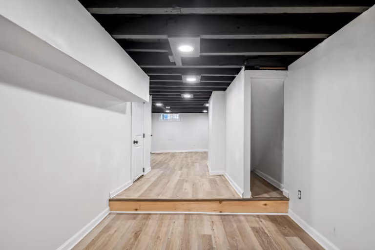 The basement with exposed dark ceiling