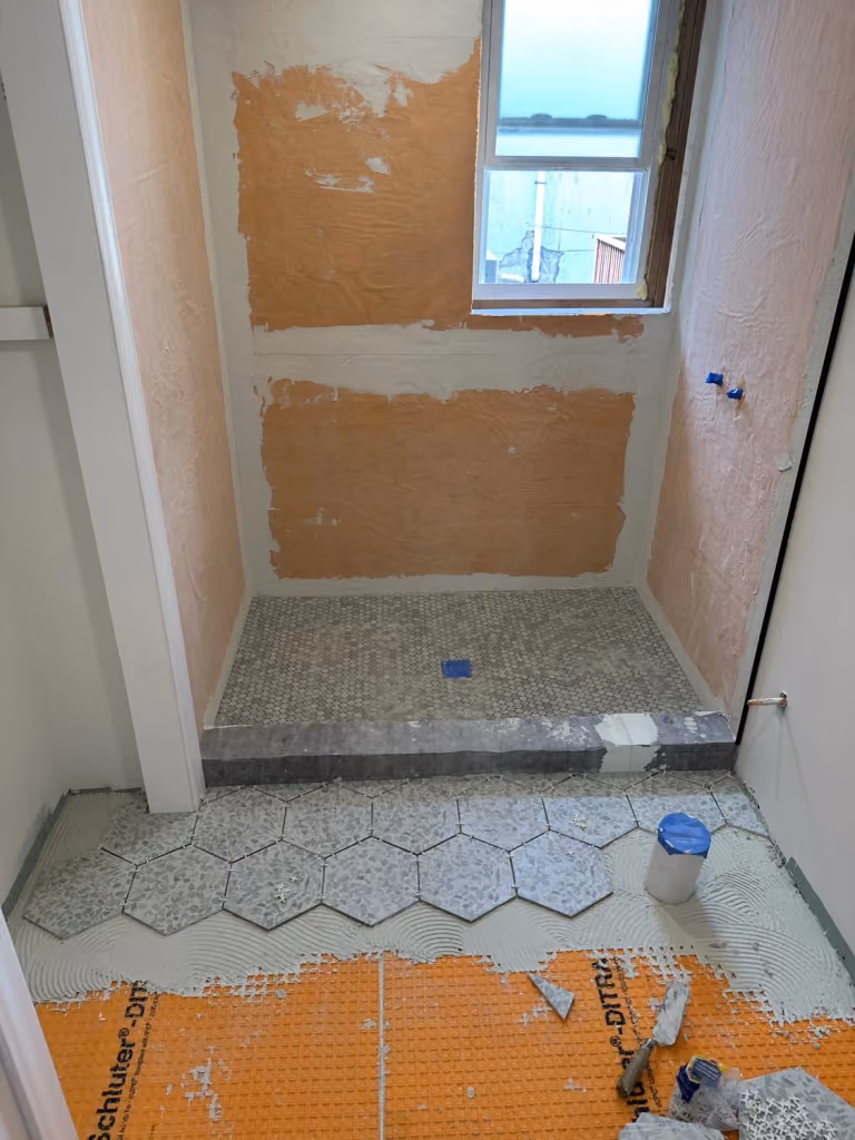 The shower room before its wall and floor finishes were complete.
