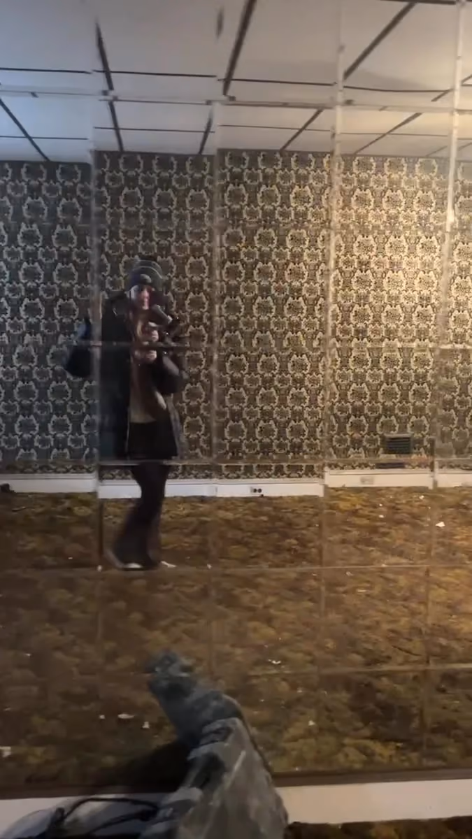The original living space, with patterned wallpaper and a suspended ceiling.