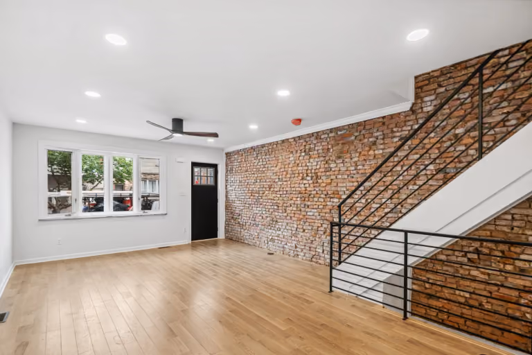 Living room, exposed brick, and stairs
